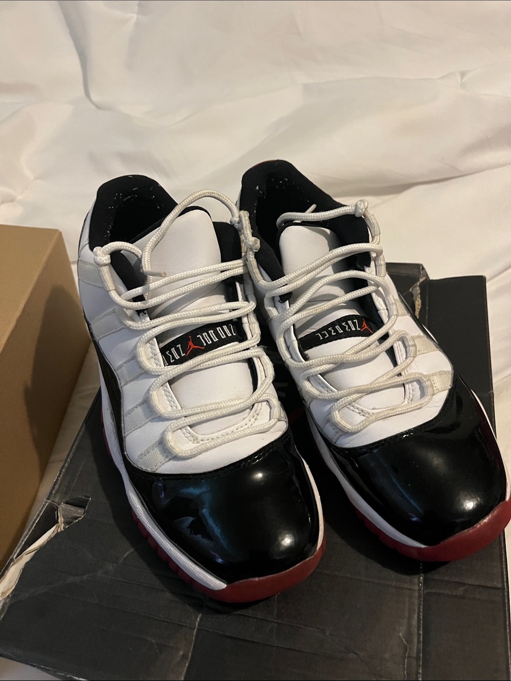 jordan’s White and Black Athletic Shoes with Red Accents